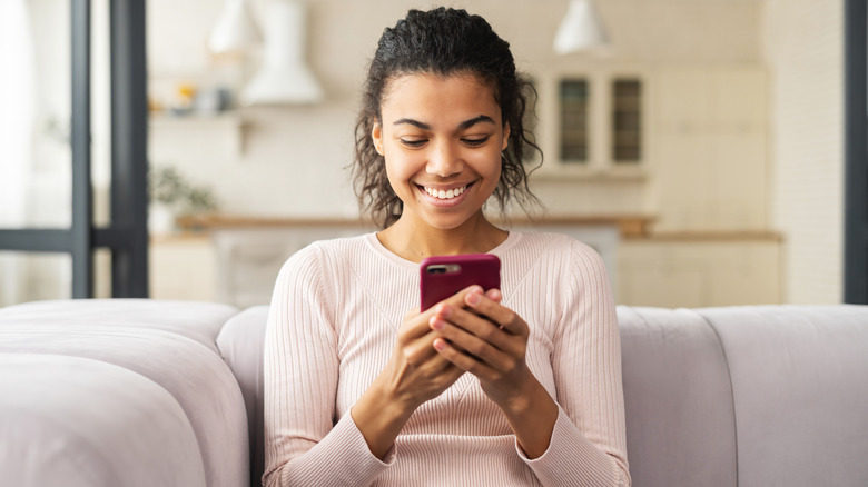 woman smiling at phone