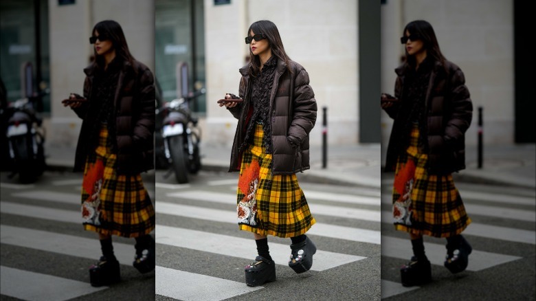 woman wearing yellow paid midi skirt