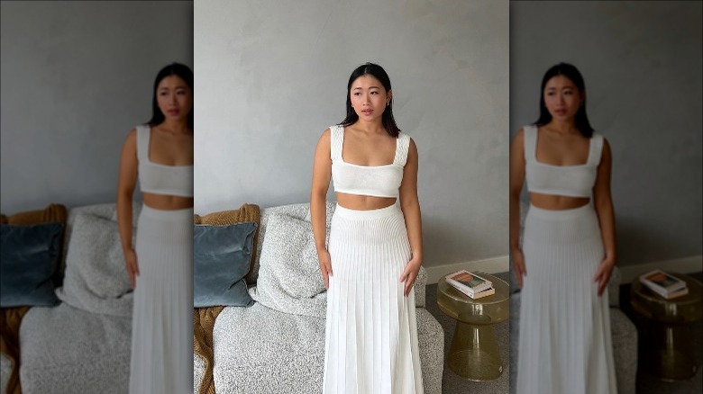 model in white crop top/skirt set