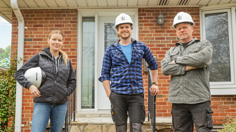 Mike Holmes on job site with Sherry and Michael Holmes, Jr.