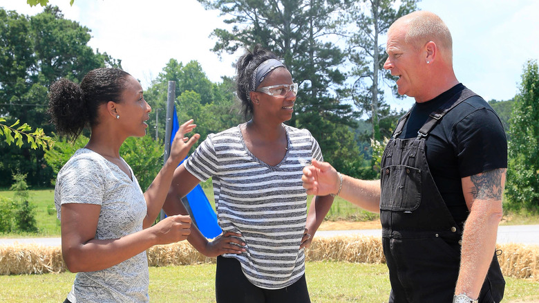 Mike Holmes talking with house flippers