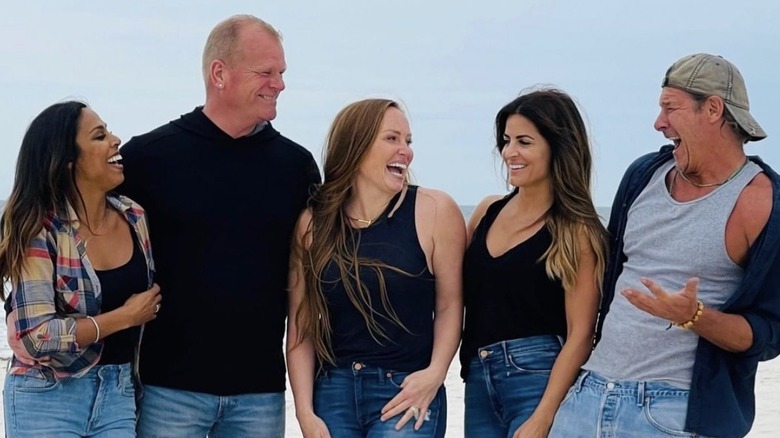 Mike Holmes smiling with the cast of Battle on the Beach