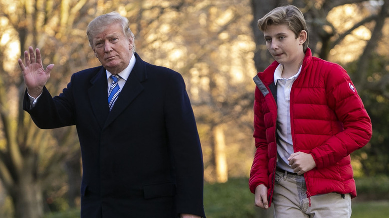 Donald Trump waving as he walks with Barron Trump 