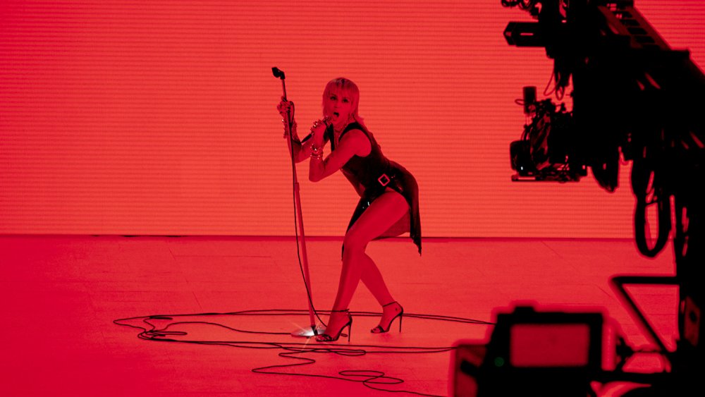 Miley Cyrus performing at the 2020 MTV VMA's in bold red lighting 