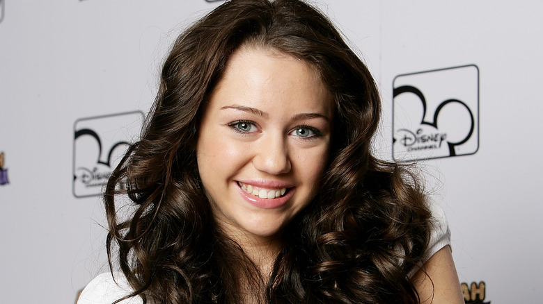 Miley Cyrus as a teen smiling