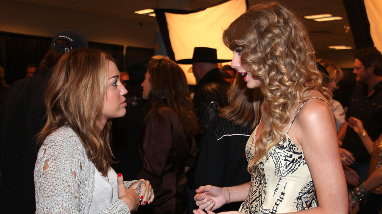 Miley Cyrus and Taylor Swift talking to one another