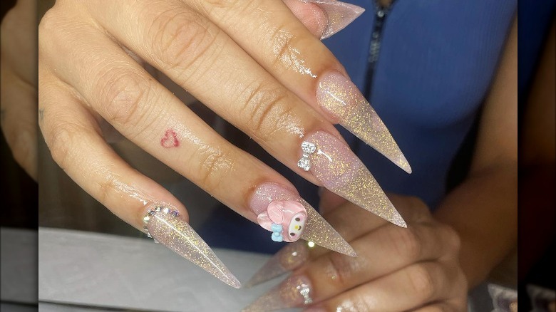 Stiletto tipped nails with gold glitter