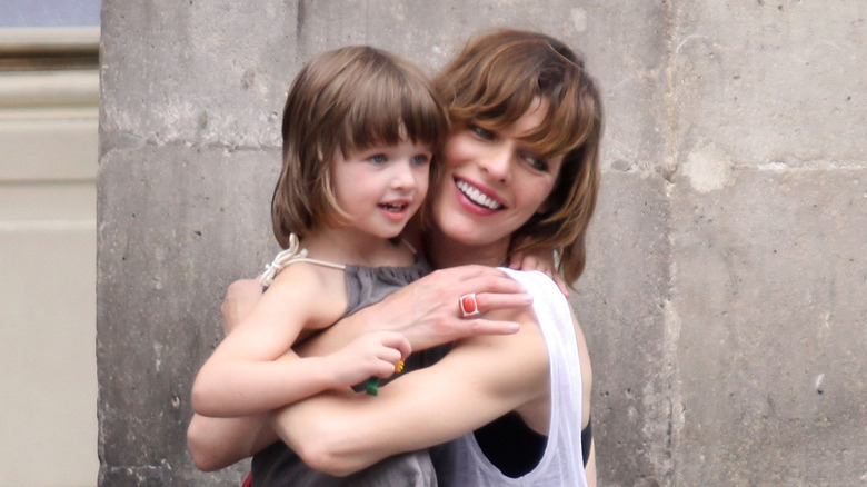 Milla Jovovich holding Ever Anderson