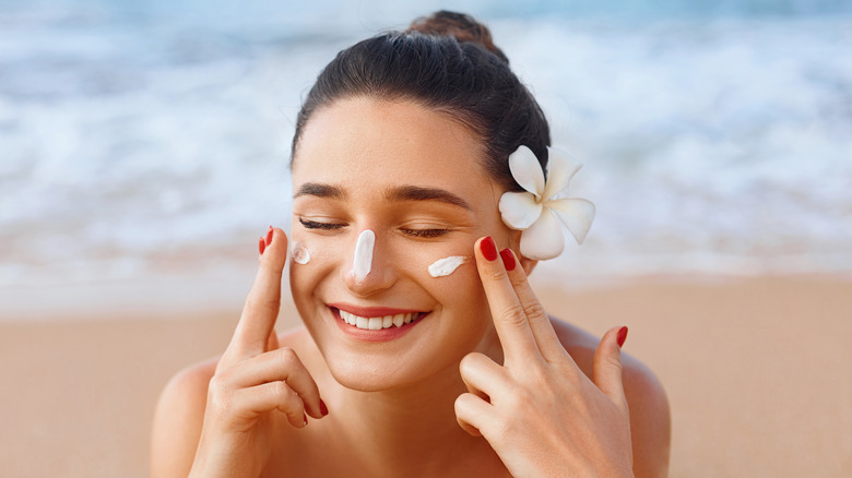 Woman applying sunscreen