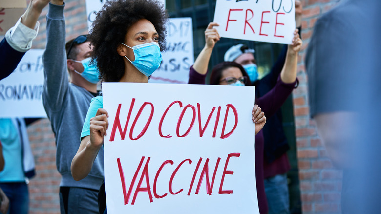 POC woman protest COVID vaccine