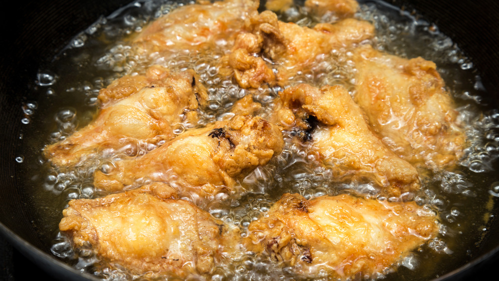 Chicken wings frying in oil