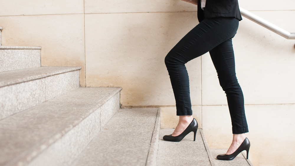 Woman climbing steps in heels