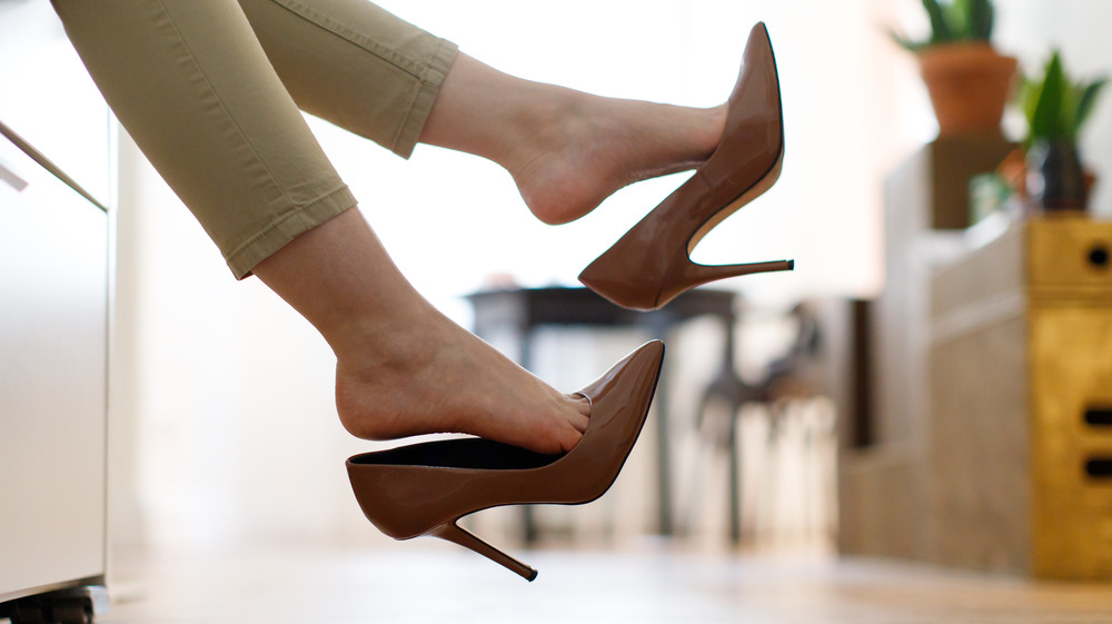 Woman kicking off her heels