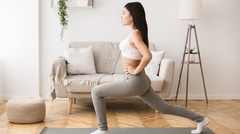 Woman doing lunge at home