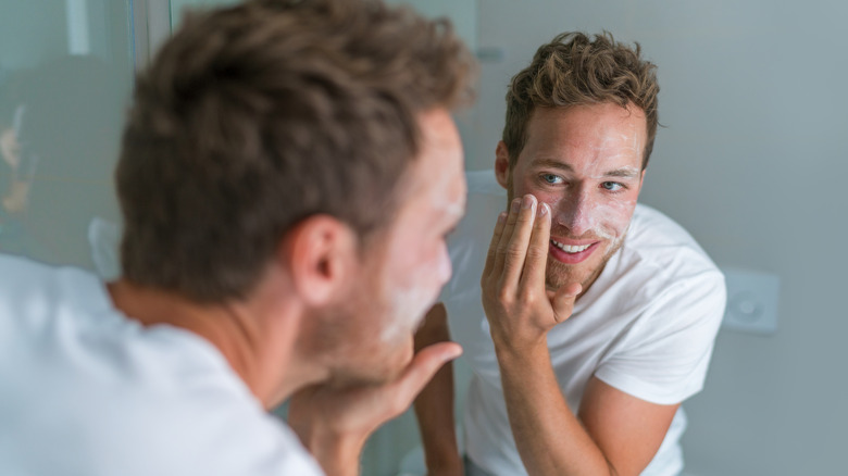 Man exfoliating face