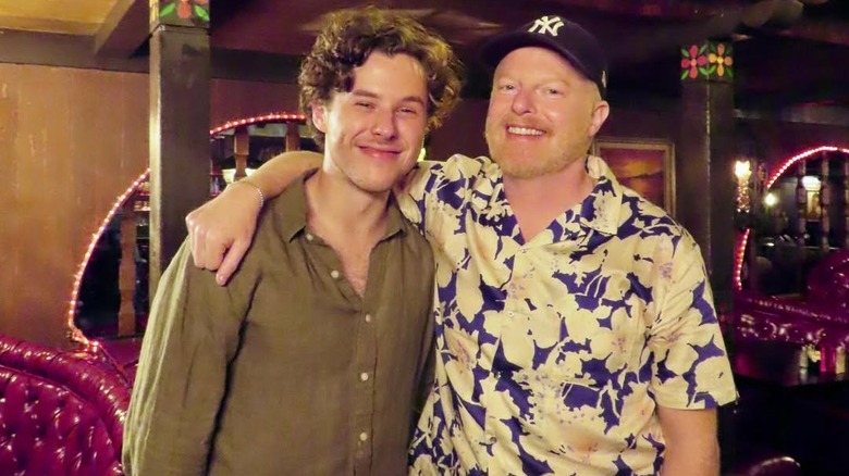 Nolan Gould and Jesse Tyler Ferguson smiling next to each other