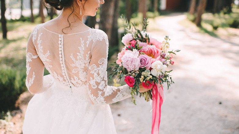 Bride holding bouquet with ribbons