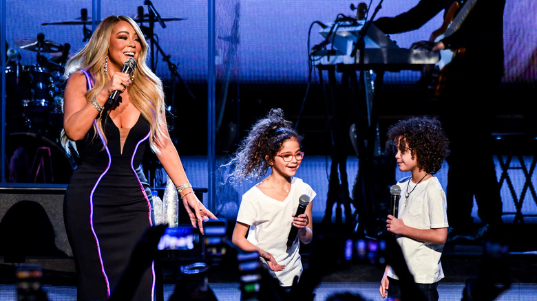 Mariah Carey, Monroe Cannon, and Moroccan Cannon on stage