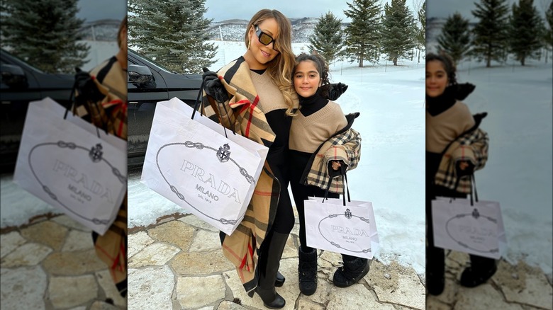 Mariah Carey and Moroccan Cannon holding Prada bags