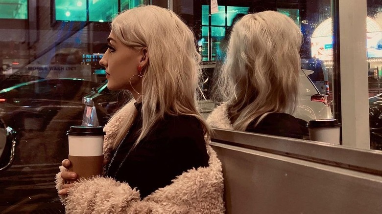 Moriah Plath poses in New York with a coffee