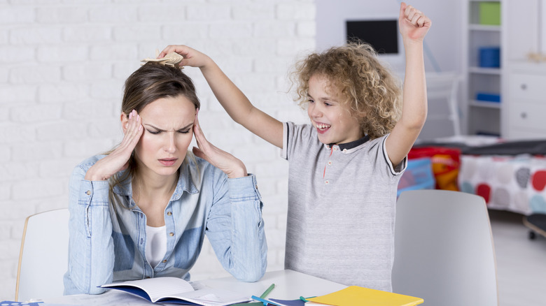 Annoyed mother with joking child