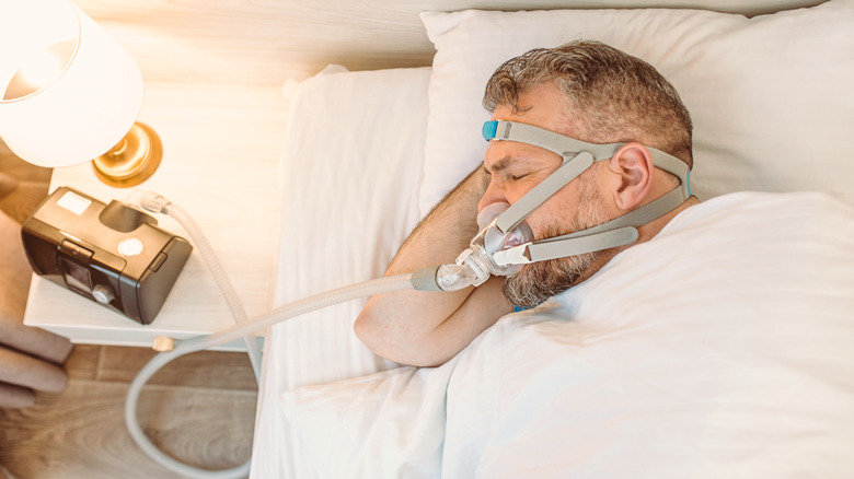 Man sleeping with CPAP machine