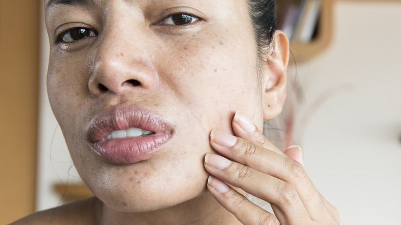 Woman touching her face