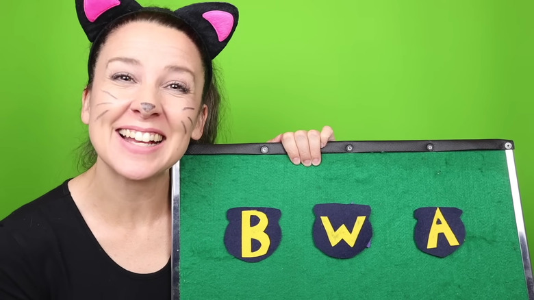 Ms. Rachel Halloween holding a felt board