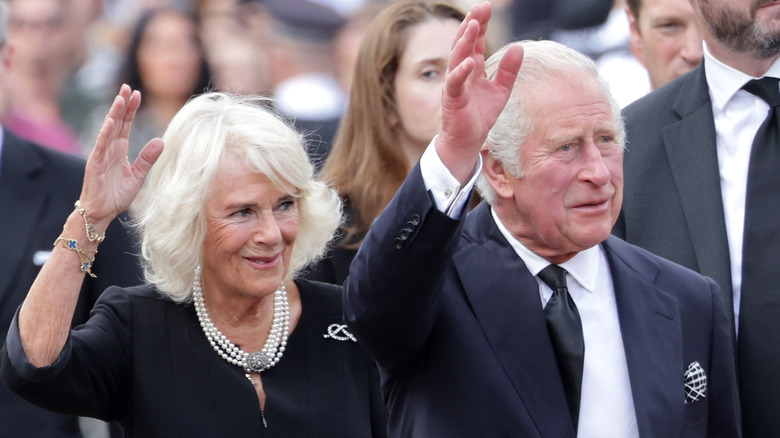 King Charles III and Queen Consort Camilla waving