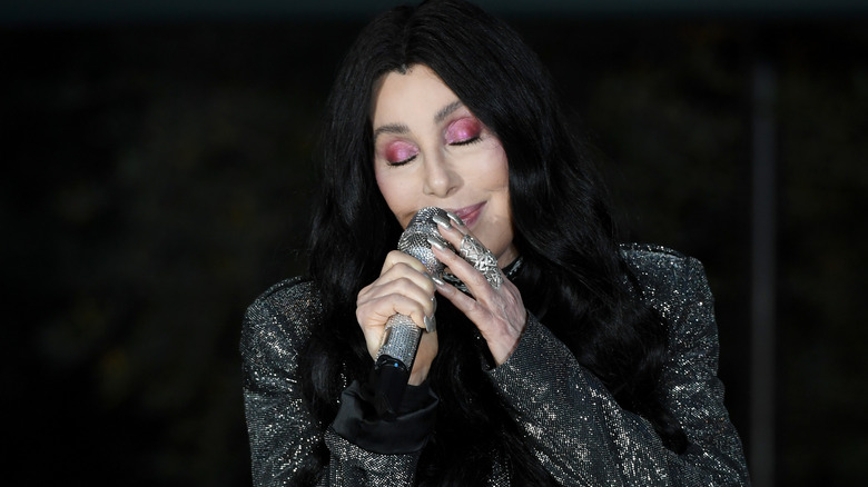 Cher in black glittery outfit and pink eyeshadow