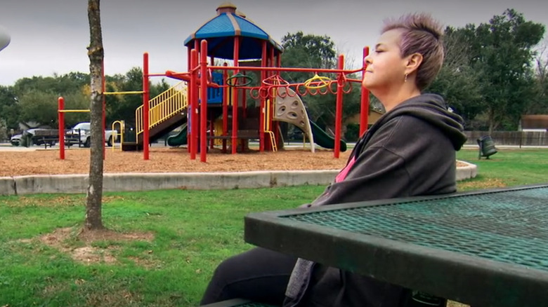 Paula Jones sitting in a park