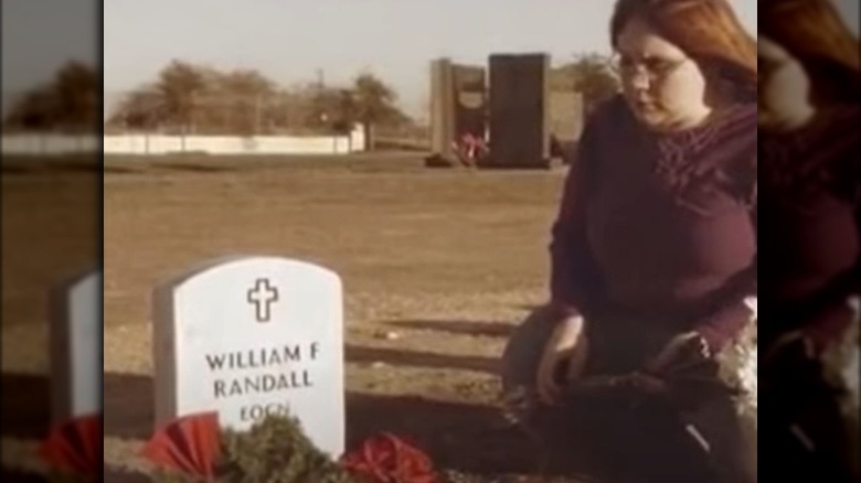 Ashley Randall sitting at a grave