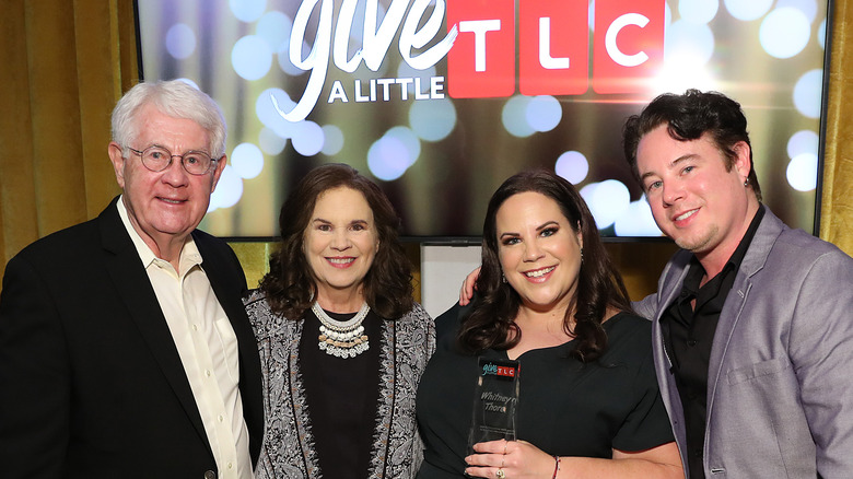 Whitney Thore poses with her parents and brother at a TLC event