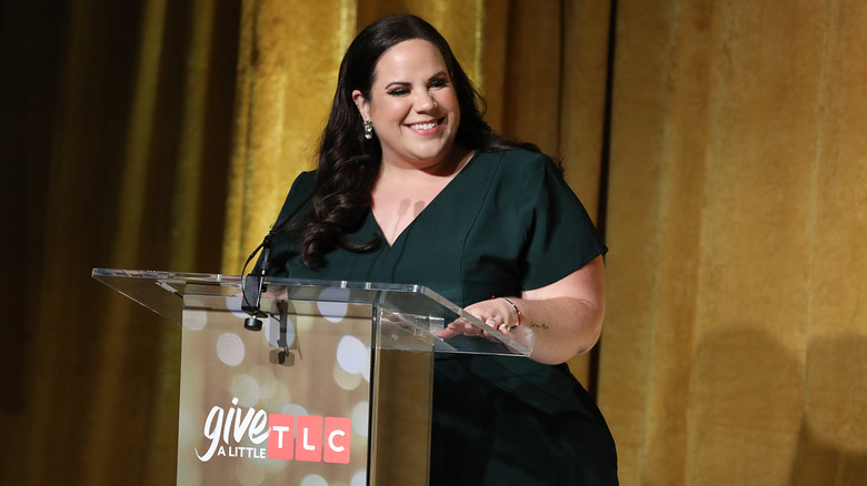 Whitney Way Thore talking onstage at an event