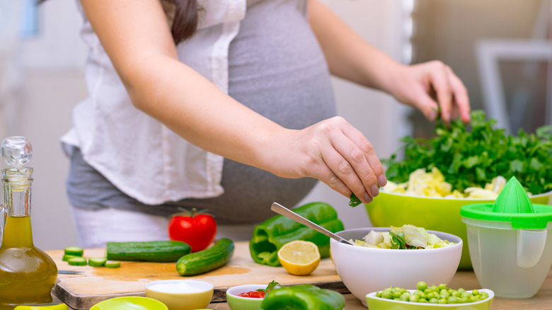 Pregnant lady preparing salad