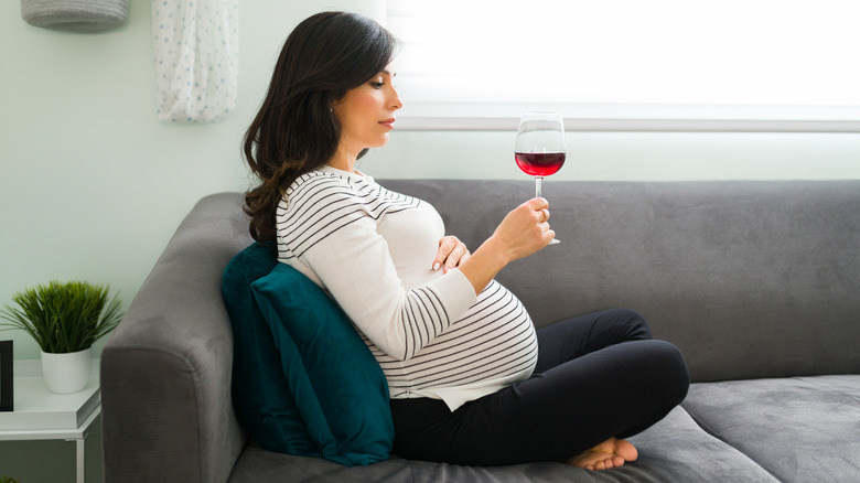 Pregnant lady drinking wine