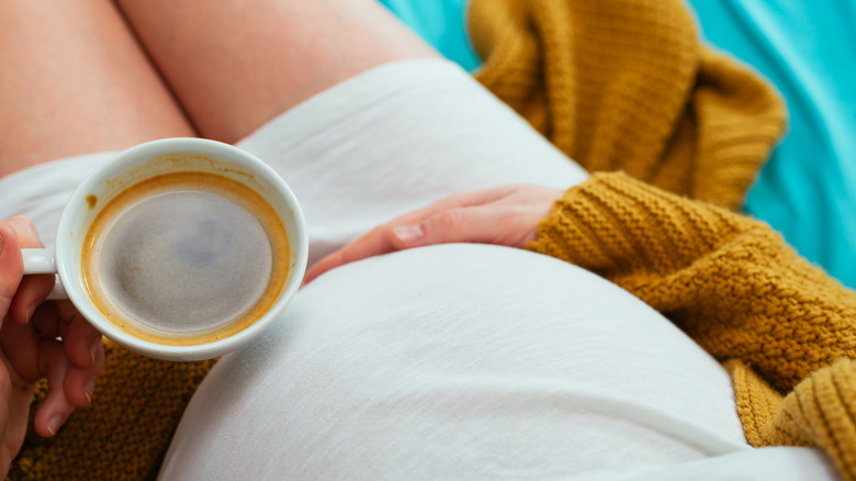 Pregnant woman with coffee