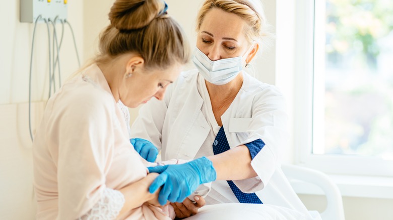 Nurse supporting breastfeeding mom