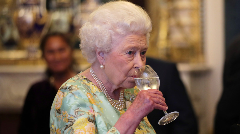 Queen Elizabeth drinking wine