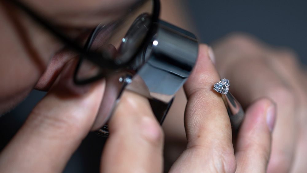 A jeweler looking at a diamond