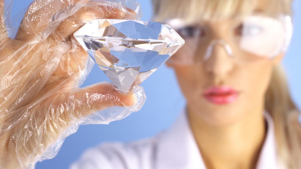 A scientist examining a large diamond