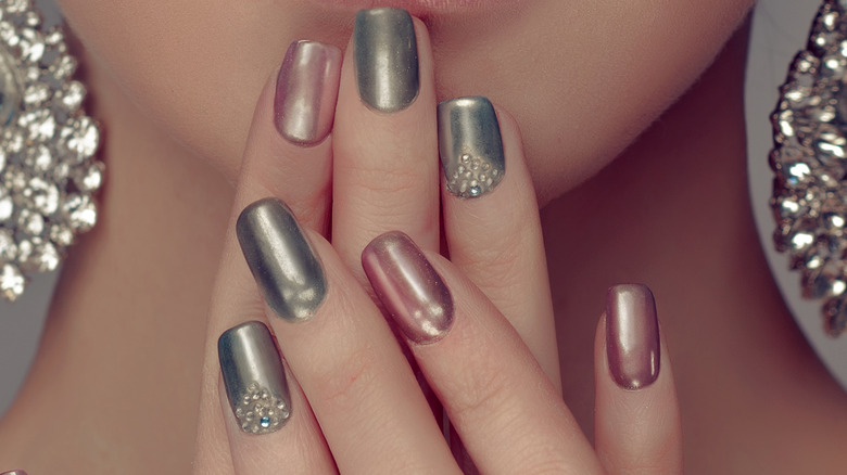 Woman with metallic gray and pink nails 