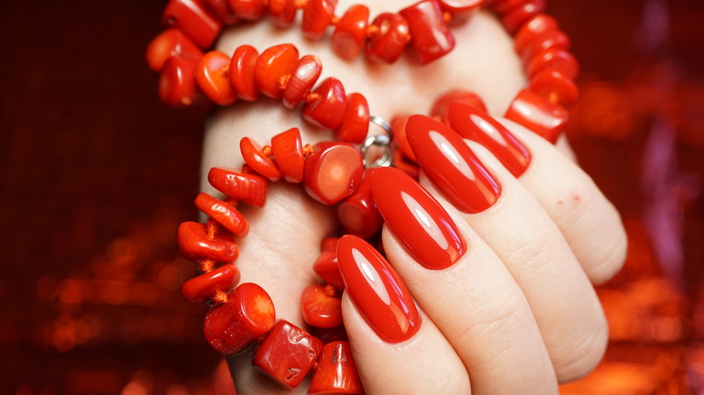 Coral beads and nails