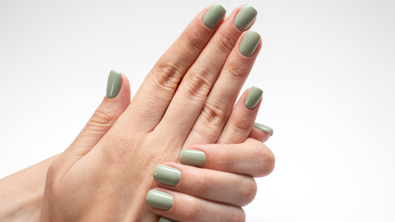 Hands with green manicure