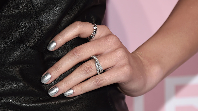 Hand with silver nails and rings