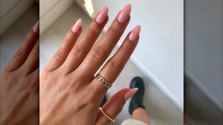 Hand with peach nails