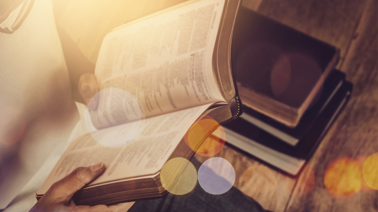 A bible with light reflecting on the pages 