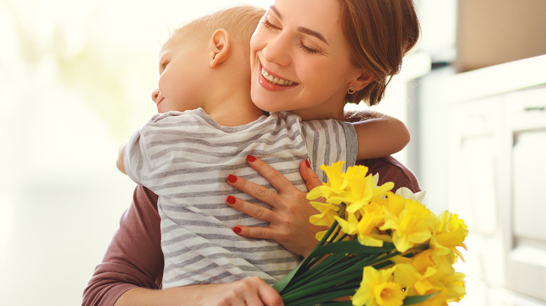 Mom holding flowers and son