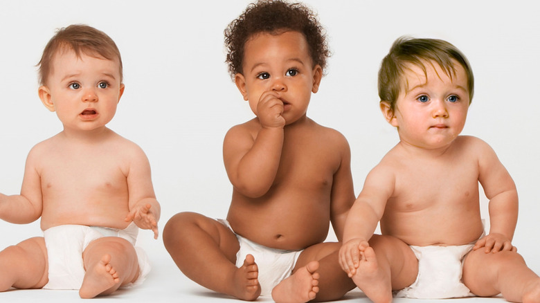 Three babies sitting down