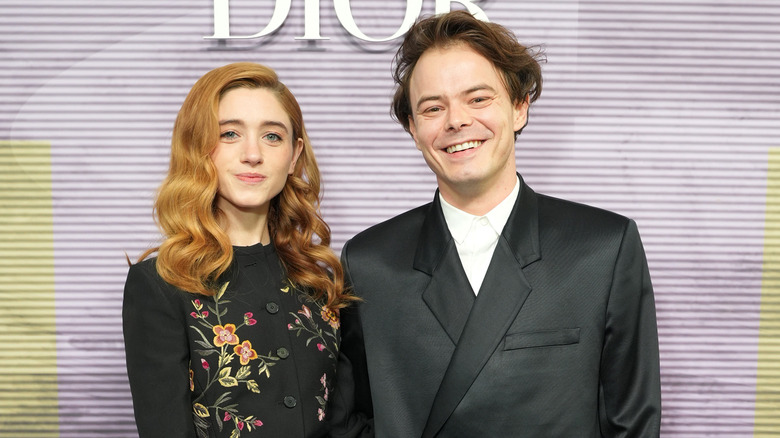 Natalia Dyer and Charlie Heaton smiling for photos